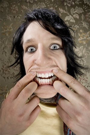 Man stretching his mouth to make a funny face Stock Photo - Budget Royalty-Free & Subscription, Code: 400-04539620