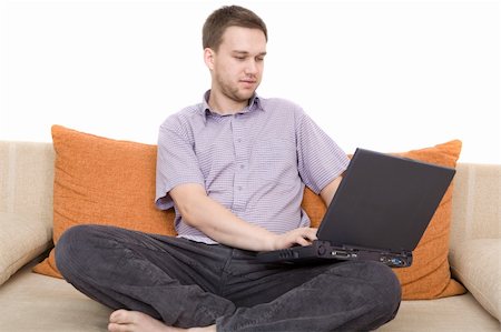 simsearch:400-04651437,k - casual man sitting on sofa with laptop Stockbilder - Microstock & Abonnement, Bildnummer: 400-04539792