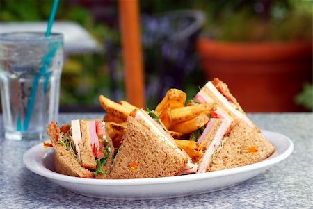 Plate with a club sandwich and French fries at an outdoor cafe Stock Photo - Budget Royalty-Free & Subscription, Code: 400-04539968