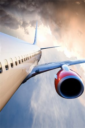 plane rain - An airplane in flight over a blue sky Stock Photo - Budget Royalty-Free & Subscription, Code: 400-04530451