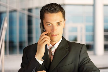 simsearch:400-04643781,k - Close-up portrait. Businessman outside a modern building with phone. Stock Photo - Budget Royalty-Free & Subscription, Code: 400-04530784