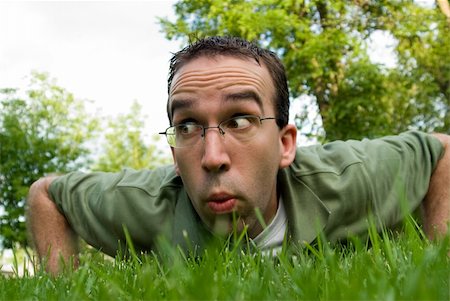 Seen from a bugs eye view, a young man creeping along the ground to find insects Stock Photo - Budget Royalty-Free & Subscription, Code: 400-04530941