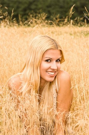 Young smiling woman in meadow outdoors portrait Stock Photo - Budget Royalty-Free & Subscription, Code: 400-04531642