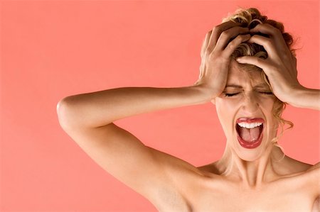 Portrait of gorgeous blonde female holding head and screaming Stock Photo - Budget Royalty-Free & Subscription, Code: 400-04531998