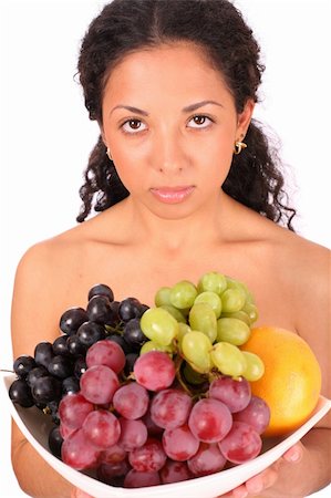 photo of model woman with grapes - A sad woman holds a plate with different kinds of fruits in her hands, standing on white background. Stock Photo - Budget Royalty-Free & Subscription, Code: 400-04532015