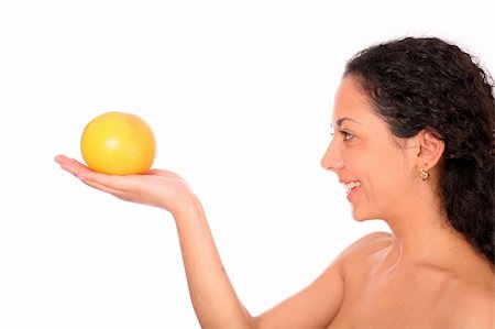 dead_morozzzka (artist) - A smiling, happy woman holds an orange in her hand and looks on it, standing on white background. Photographie de stock - Aubaine LD & Abonnement, Code: 400-04532021