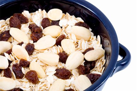 porridge bowl - a bowl of oatmeal with raisins and almonds - healthy diet Stock Photo - Budget Royalty-Free & Subscription, Code: 400-04532158