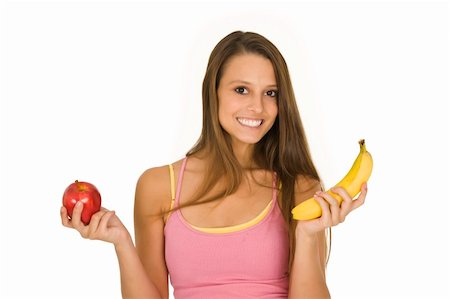 pretty women eating banana - Caucasian woman holding an apple and a banana trying to decide which one to eat Photographie de stock - Aubaine LD & Abonnement, Code: 400-04532238
