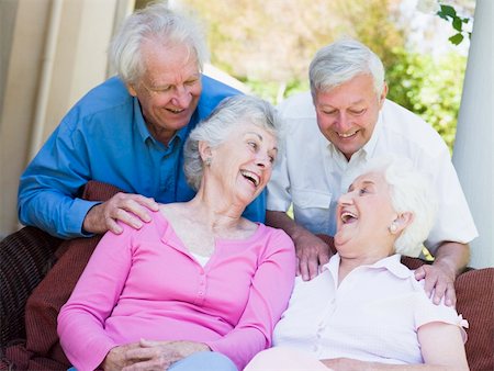 simsearch:400-05314664,k - Group of senior friends sitting on garden seat laughing Stock Photo - Budget Royalty-Free & Subscription, Code: 400-04532916