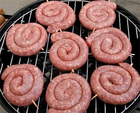 Thuringian Bratwurst (round fried sausage) on a barbecue grill (german delicacy) Stock Photo - Budget Royalty-Free & Subscription, Code: 400-04533032