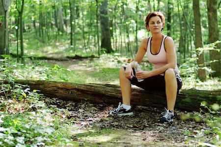 exhausted sweaty female runner - Mature woman runner resting in woods. Stock Photo - Budget Royalty-Free & Subscription, Code: 400-04533051