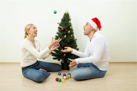 The pair juggles with spheres sitting at a Christmas pine Stock Photo - Budget Royalty-Free & Subscription, Code: 400-04544854