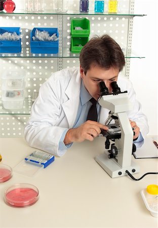 simsearch:400-05670478,k - A scientist observes an object under magnification of a microscope in the laboratory Stock Photo - Budget Royalty-Free & Subscription, Code: 400-04544974