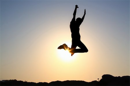 silhouette of a young male jumping over sunset background Stock Photo - Budget Royalty-Free & Subscription, Code: 400-04545135