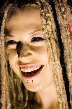 sinister smile - Laughing Woman with Face Piercings and Dread Lock Hair Stock Photo - Budget Royalty-Free & Subscription, Code: 400-04545795