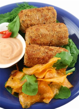 simsearch:400-04055000,k - Crumbed tuna croquettes with sweet potatoes and a rocket salad. Photographie de stock - Aubaine LD & Abonnement, Code: 400-04546917
