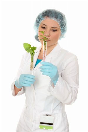 Scientist looking at test tube experiments she is holding in her hands. Stock Photo - Budget Royalty-Free & Subscription, Code: 400-04547399