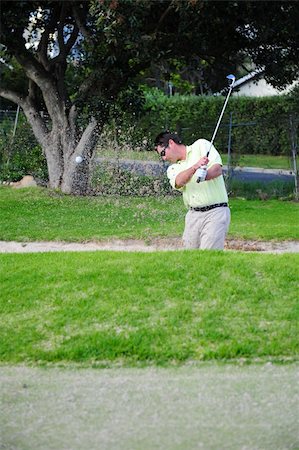 simsearch:400-03975619,k - A professional golfer playing a shot out of a sand-trap with excellent control. Stock Photo - Budget Royalty-Free & Subscription, Code: 400-04547837