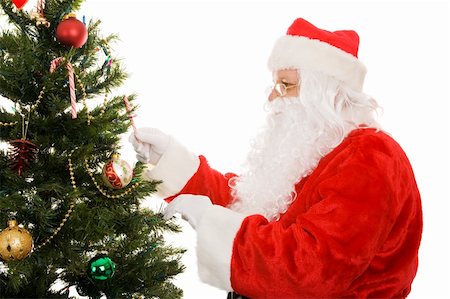 simsearch:400-05008640,k - Santa Claus decorating a Christmas tree.  Isolated on white background. Photographie de stock - Aubaine LD & Abonnement, Code: 400-04548124