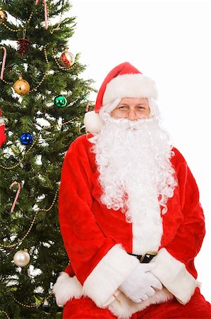 simsearch:400-05008640,k - Santa Claus sitting under the Christmas tree.  Isolated on white. Photographie de stock - Aubaine LD & Abonnement, Code: 400-04548441