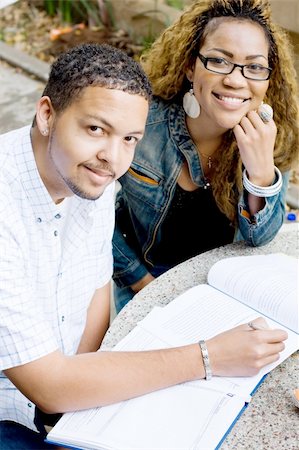 Two african american college students friends study a book together outdoors Stock Photo - Budget Royalty-Free & Subscription, Code: 400-04549325
