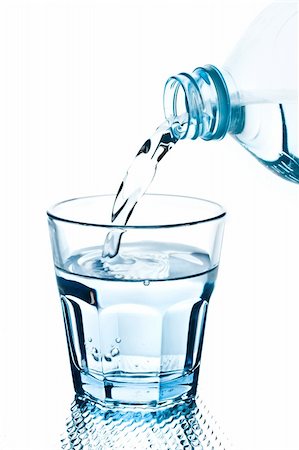 bottle pouring water into a blue glass Foto de stock - Royalty-Free Super Valor e Assinatura, Número: 400-04549548