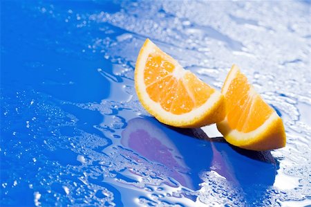 Orange slices on wet blue surface with reflections Stock Photo - Budget Royalty-Free & Subscription, Code: 400-04549926