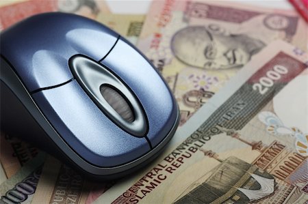 Mouse with indian and iranian currency in background Stock Photo - Budget Royalty-Free & Subscription, Code: 400-04540101