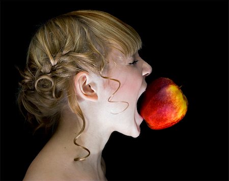 simsearch:400-05014700,k - girl,eating apple over the black background Fotografie stock - Microstock e Abbonamento, Codice: 400-04540220