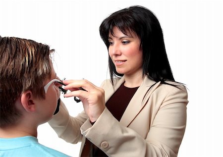 An optometrist puts trial frames on a patient Stockbilder - Microstock & Abonnement, Bildnummer: 400-04540240