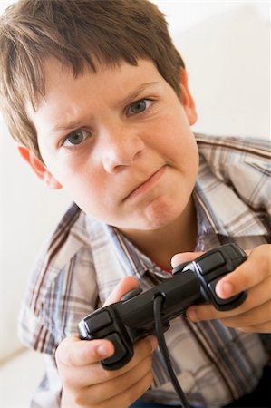 simsearch:400-04200279,k - Young boy holding video game controller looking confused Stock Photo - Budget Royalty-Free & Subscription, Code: 400-04540509