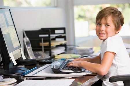 simsearch:400-04044137,k - Young boy in home office with computer smiling Stock Photo - Budget Royalty-Free & Subscription, Code: 400-04540519