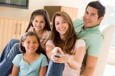 simsearch:400-04045202,k - Family in living room with remote control smiling Stock Photo - Budget Royalty-Free & Subscription, Code: 400-04540522