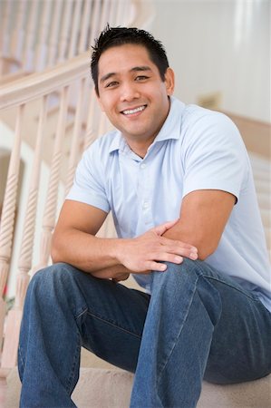 spiral staircase people - Man sitting on staircase smiling Stock Photo - Budget Royalty-Free & Subscription, Code: 400-04540761