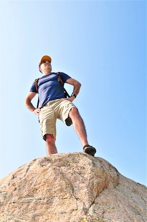 simsearch:400-08506088,k - Middle aged hiker standing on top of a mountain Fotografie stock - Microstock e Abbonamento, Codice: 400-04540827