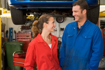 simsearch:400-05735179,k - Two mechanics standing in garage smiling Stockbilder - Microstock & Abonnement, Bildnummer: 400-04540986