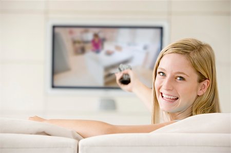 simsearch:400-04045202,k - Woman in living room watching television smiling Stock Photo - Budget Royalty-Free & Subscription, Code: 400-04540999