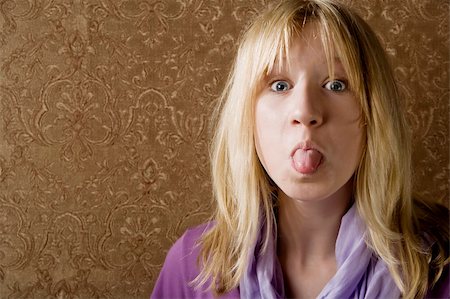 Pretty young girl sticking out her tongue Stock Photo - Budget Royalty-Free & Subscription, Code: 400-04541011