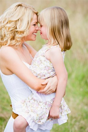 simsearch:400-04043055,k - Mother holding daughter outdoors smiling Stock Photo - Budget Royalty-Free & Subscription, Code: 400-04541069