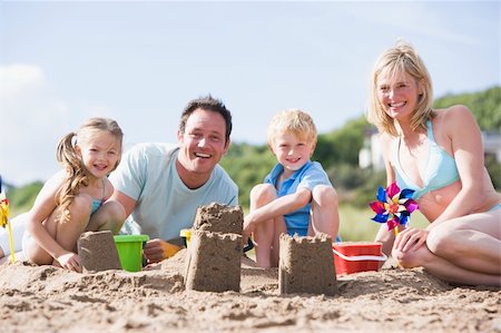 Family on beach making sand castles smiling Stock Photo - Budget Royalty-Free & Subscription, Code: 400-04541179