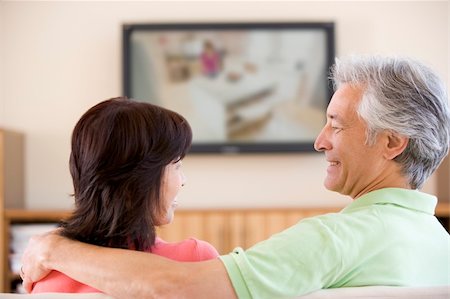 Couple watching television smiling Stock Photo - Budget Royalty-Free & Subscription, Code: 400-04541248