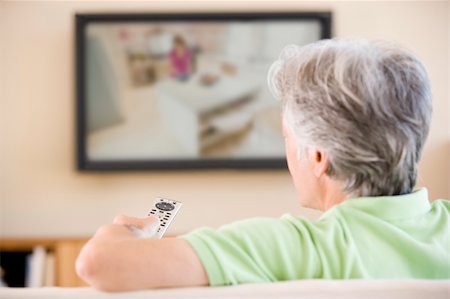simsearch:400-04046300,k - Man watching television using remote control Stock Photo - Budget Royalty-Free & Subscription, Code: 400-04541249