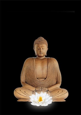 Buddha smiling, with eyes closed in prayer with a glowing white lotus lily flower in the foreground, over black background. Stock Photo - Budget Royalty-Free & Subscription, Code: 400-04541759