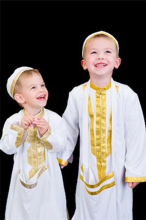 simsearch:400-04547844,k - Cute little 3yr and 5yr old boys wearing traditional Arabian thobes for the purpose of asking for Ramadan treats. Stock Photo - Budget Royalty-Free & Subscription, Code: 400-04542365