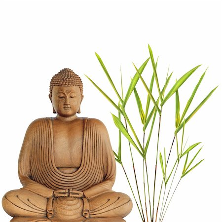simsearch:400-05297167,k - Buddha in meditation with bamboo leaf grass, over white background. Fotografie stock - Microstock e Abbonamento, Codice: 400-04542910