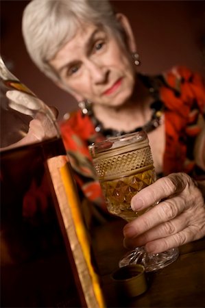 simsearch:400-04278950,k - Senior woman alcoholic with a bottle of booze Fotografie stock - Microstock e Abbonamento, Codice: 400-04542927