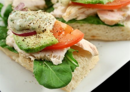 simsearch:400-04613511,k - Fresh open chicken finger sandwiches with avocado red onion and mayo with lettuce Fotografie stock - Microstock e Abbonamento, Codice: 400-04543263