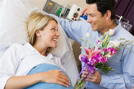pregnant hospital couple - Man Giving His Pregnant Wife Flowers Stock Photo - Budget Royalty-Free & Subscription, Code: 400-04543729
