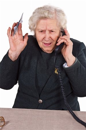 Old woman having emotional phone conversation with money in her hand Photographie de stock - Aubaine LD & Abonnement, Code: 400-04554179