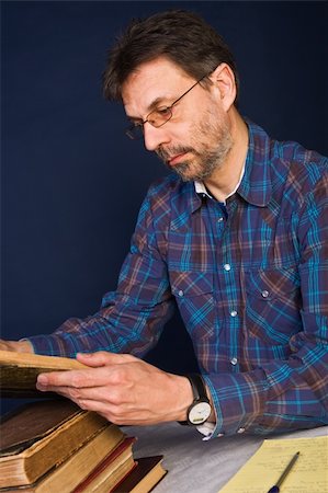 scientist and teacher photo - Professor at work, working with very old books and taking notes Stock Photo - Budget Royalty-Free & Subscription, Code: 400-04554170